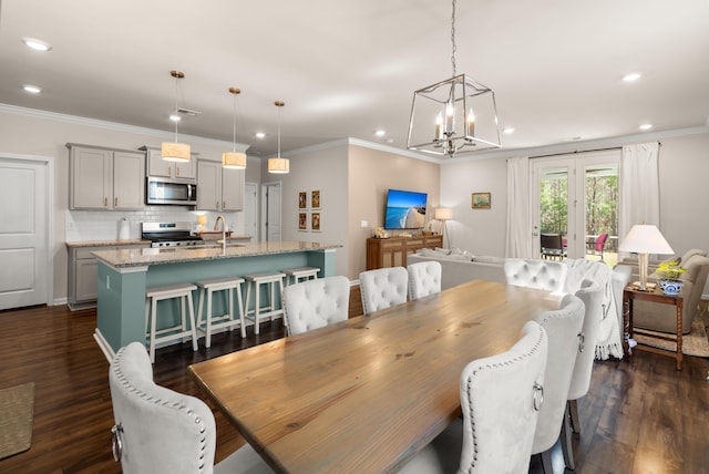 dining room featuring an inviting chandelier, dark wood-type flooring, recessed lighting, and crown molding