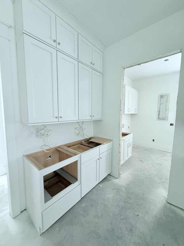 interior space featuring white cabinetry and sink