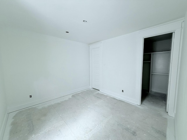 unfurnished bedroom with a spacious closet and a closet