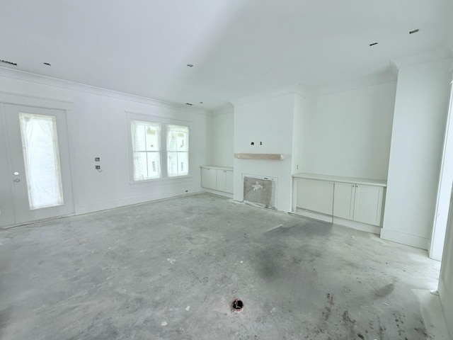 unfurnished living room featuring crown molding