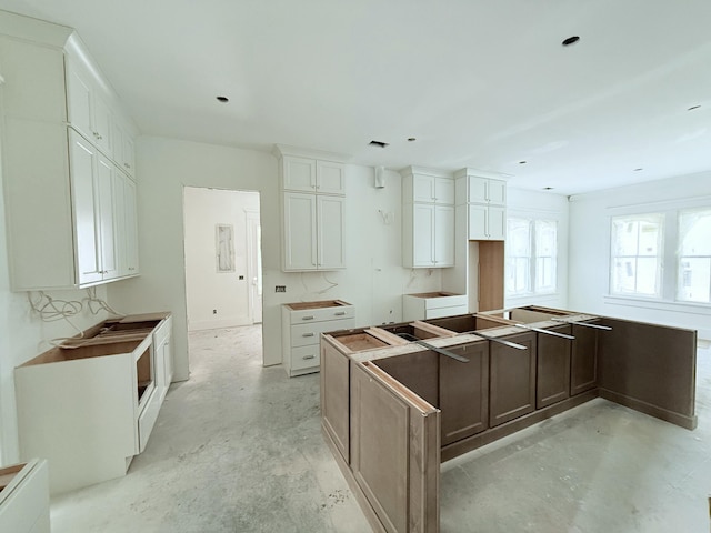 kitchen with a center island and white cabinets