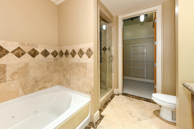 bathroom featuring plus walk in shower, toilet, and tile walls