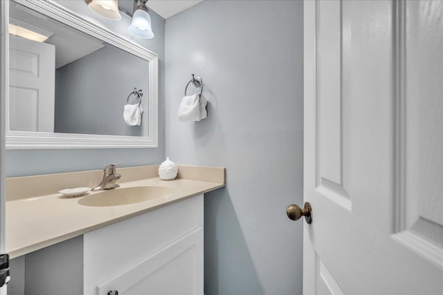 bathroom featuring a textured ceiling and vanity