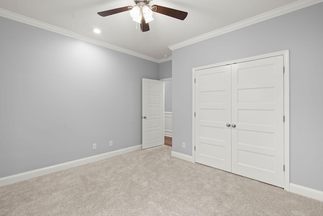 unfurnished bedroom featuring carpet, baseboards, a closet, and ornamental molding