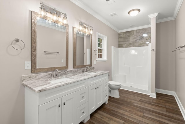 bathroom featuring a walk in shower, a sink, toilet, and wood finished floors