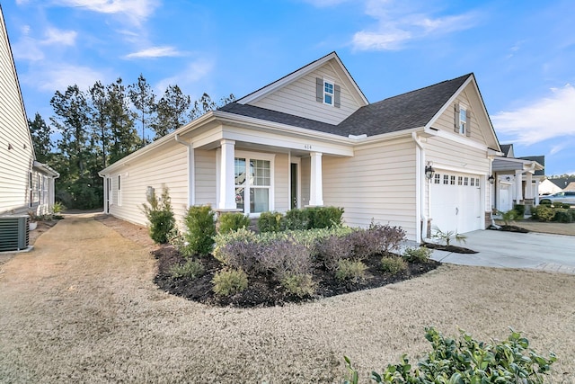 view of front of property featuring a garage and cooling unit