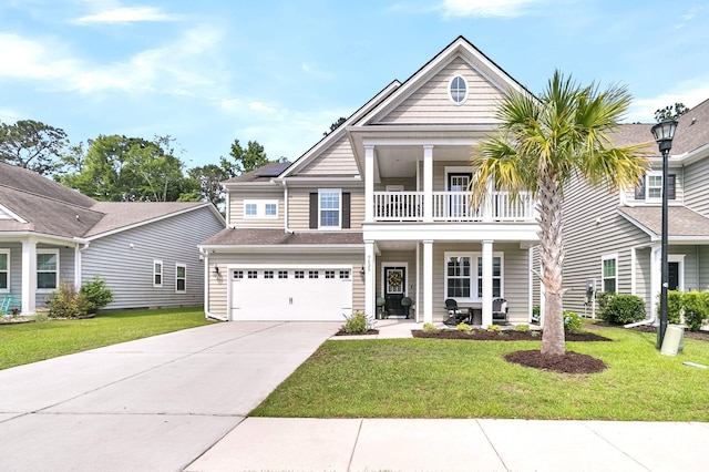 9829 English Elm St, Ladson, SC 29456 - view of front of house with a balcony, driveway, a porch, and a front lawn