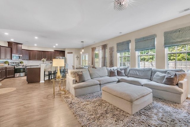 9829 English Elm St, Ladson, SC 29456 - living room with light wood finished floors, plenty of natural light, and recessed lighting