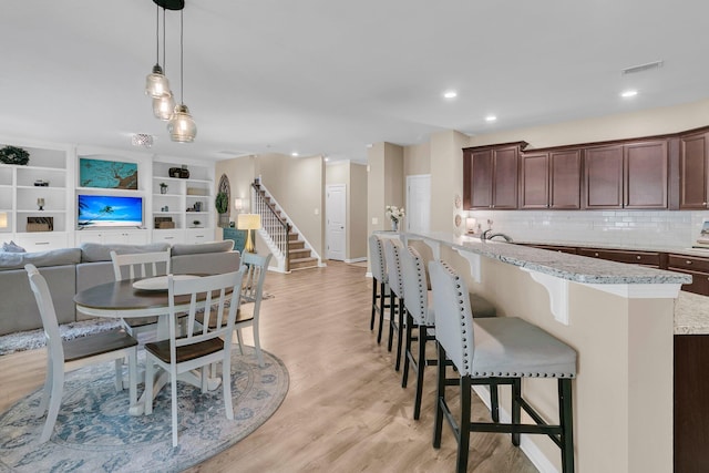 9829 English Elm St, Ladson, SC 29456 - dining area with light wood-type flooring, baseboards, stairs, and recessed lighting
