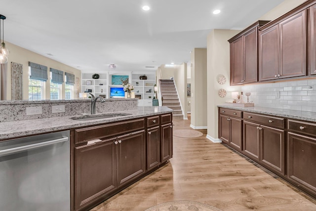 9829 English Elm St, Ladson, SC 29456 - kitchen with stainless steel dishwasher, a sink, tasteful backsplash, light stone countertops, and light wood-style flooring