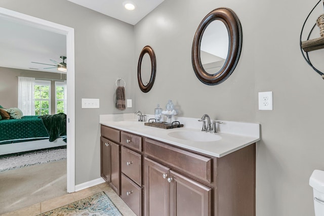 9829 English Elm St, Ladson, SC 29456 - ensuite bathroom featuring a ceiling fan, double vanity, tile patterned flooring, baseboards, and toilet