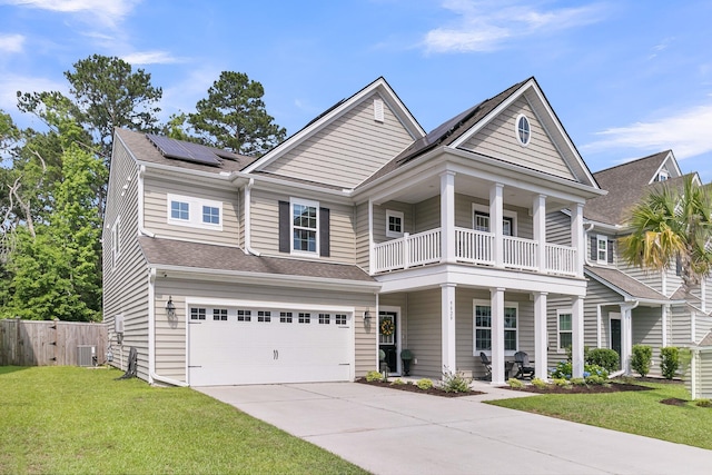 9829 English Elm St, Ladson, SC 29456 - view of front of house with a balcony, roof mounted solar panels, central AC, a porch, and driveway