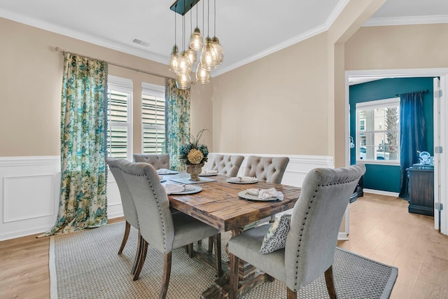 9829 English Elm St, Ladson, SC 29456 - dining space featuring ornamental molding, light wood-type flooring, wainscoting, and a chandelier