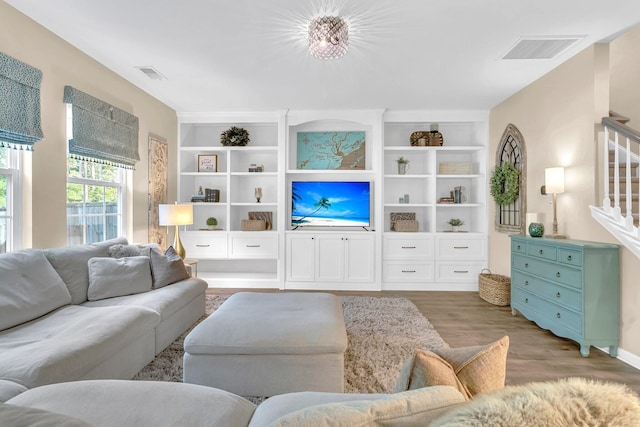 9829 English Elm St, Ladson, SC 29456 - living room featuring wood finished floors, built in shelves, and stairs