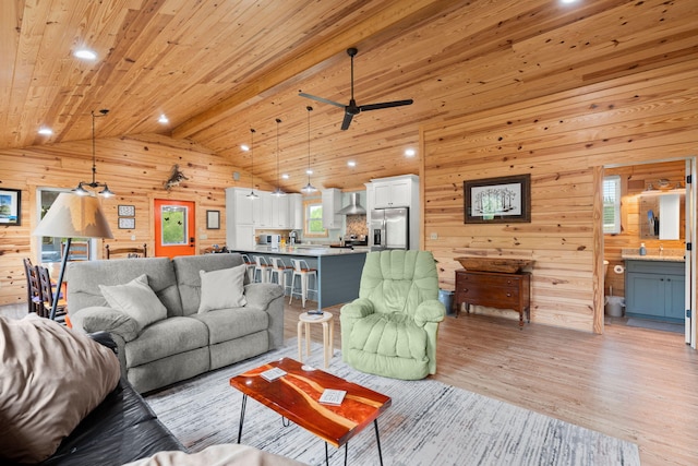 5653 Wire Rd, Branchville, SC 29432 - living area featuring wood walls, a ceiling fan, vaulted ceiling with beams, wooden ceiling, and light wood-style floors
