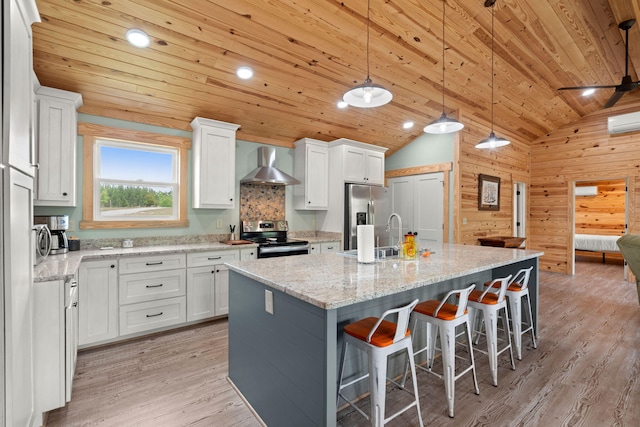 5653 Wire Rd, Branchville, SC 29432 - kitchen with vaulted ceiling, a sink, wood ceiling, wall chimney exhaust hood, and appliances with stainless steel finishes