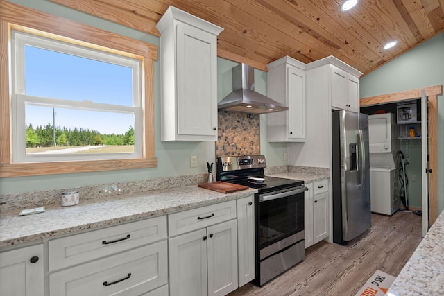 5653 Wire Rd, Branchville, SC 29432 - kitchen with stacked washer / dryer, stainless steel appliances, wooden ceiling, wall chimney exhaust hood, and lofted ceiling