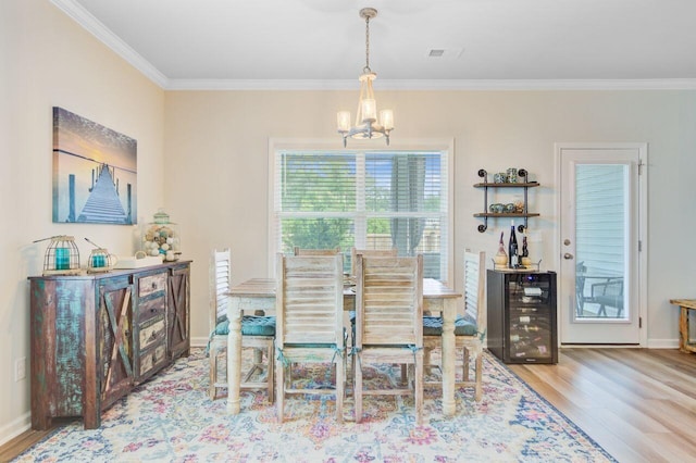 266 Torslanda Ln, Summerville, SC 29486 - dining room with a chandelier, wine cooler, crown molding, wood finished floors, and baseboards
