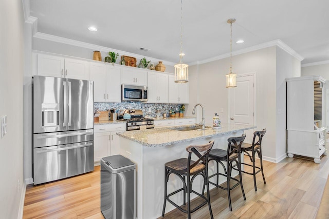 266 Torslanda Ln, Summerville, SC 29486 - kitchen featuring appliances with stainless steel finishes, a sink, white cabinets, ornamental molding, and recessed lighting