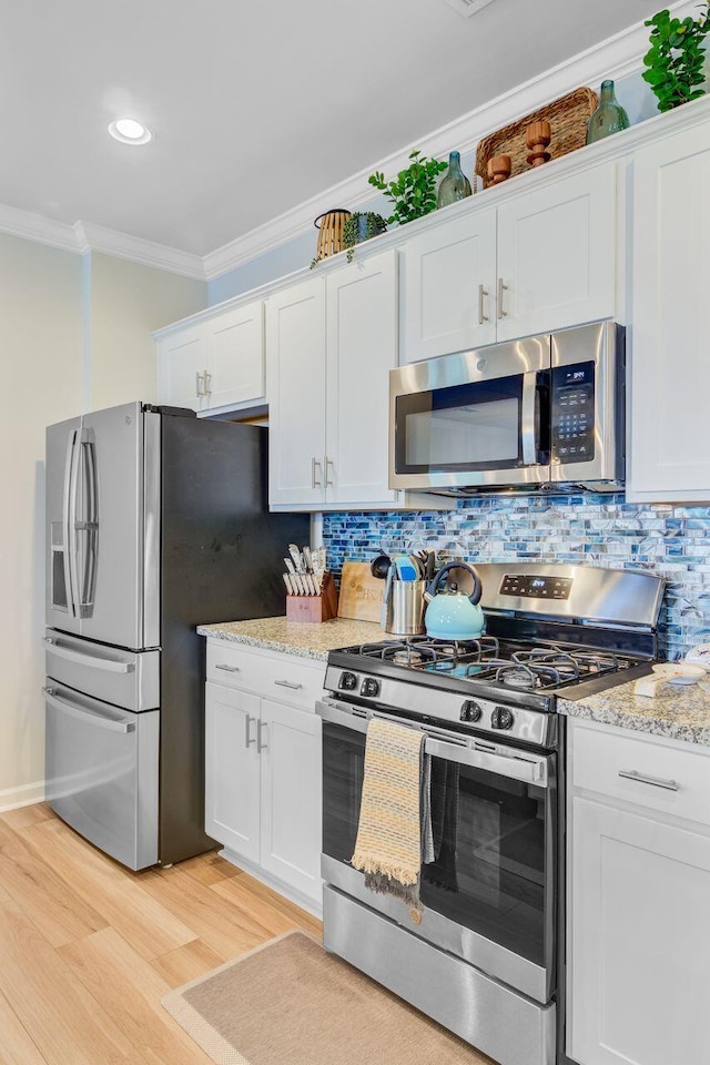 266 Torslanda Ln, Summerville, SC 29486 - kitchen featuring appliances with stainless steel finishes, crown molding, light wood-type flooring, white cabinetry, and backsplash