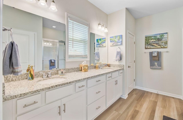 266 Torslanda Ln, Summerville, SC 29486 - bathroom featuring double vanity, a shower stall, wood finished floors, and baseboards