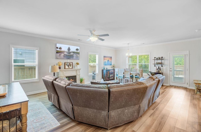 266 Torslanda Ln, Summerville, SC 29486 - living room featuring ceiling fan, light wood-style floors, crown molding, a glass covered fireplace, and baseboards