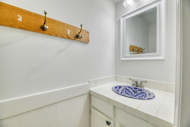 bathroom with wainscoting and vanity