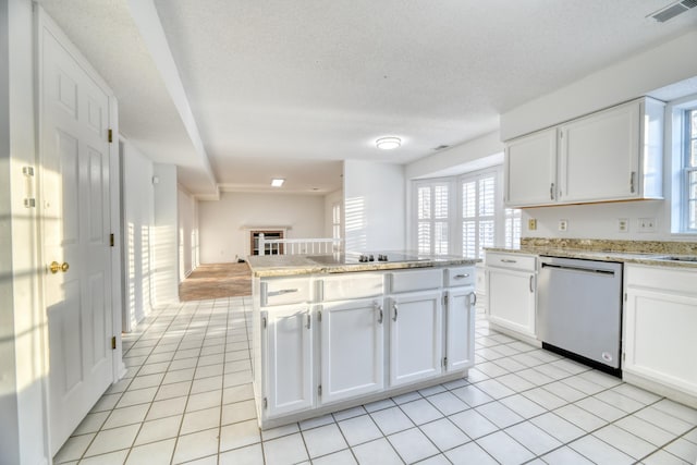 kitchen featuring black electric stovetop, light tile patterned flooring, visible vents, white cabinetry, and stainless steel dishwasher