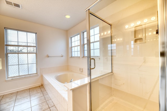 bathroom with a textured ceiling, a garden tub, visible vents, tile patterned floors, and a stall shower