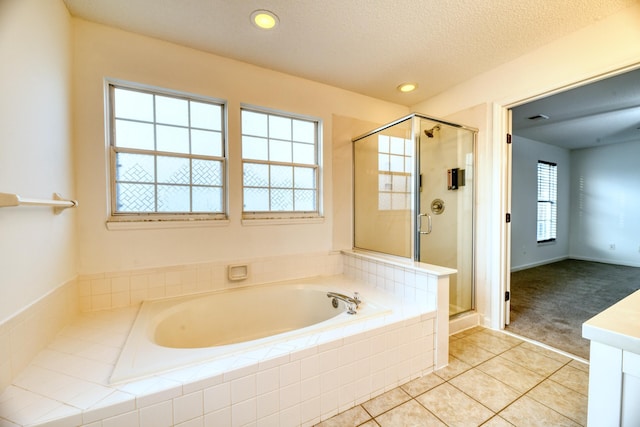 bathroom with a garden tub, recessed lighting, a stall shower, a textured ceiling, and tile patterned flooring