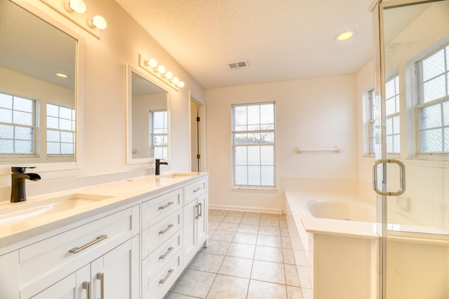 full bath with tile patterned flooring, visible vents, a sink, and a textured ceiling