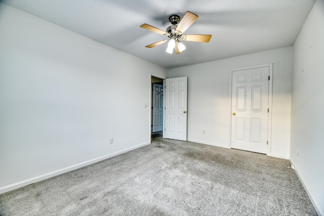 unfurnished bedroom featuring carpet, baseboards, and ceiling fan