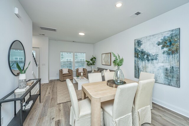 dining space featuring light wood-type flooring, baseboards, visible vents, and recessed lighting