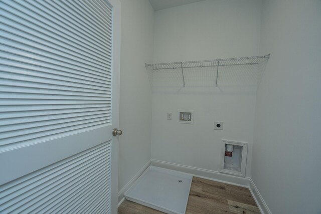 laundry area with hookup for a washing machine, laundry area, wood finished floors, baseboards, and electric dryer hookup