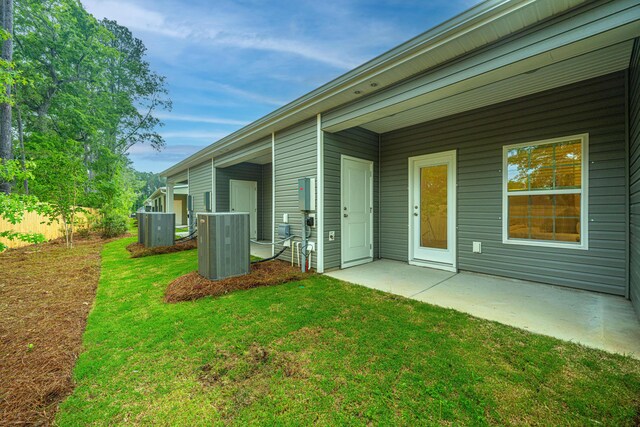 exterior space featuring central AC, a lawn, and a patio