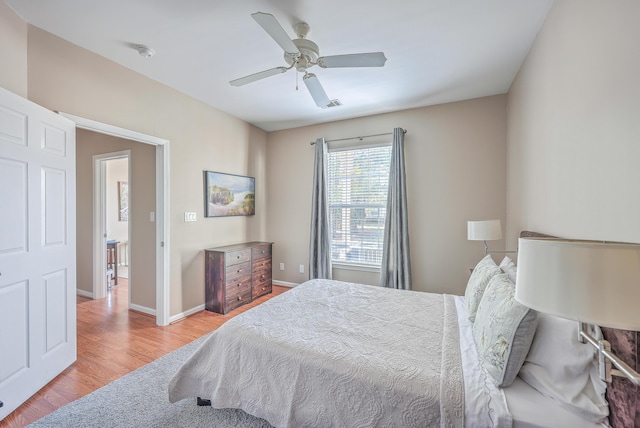 bedroom with ceiling fan and light wood-type flooring