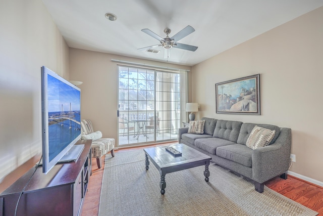 living room with ceiling fan and hardwood / wood-style flooring