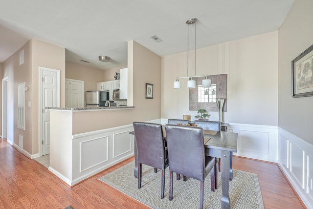 dining space featuring light hardwood / wood-style floors