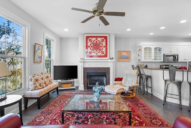 living room featuring dark hardwood / wood-style floors and ceiling fan