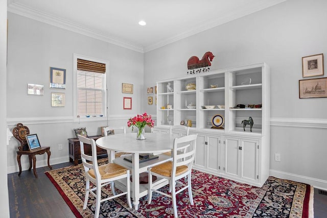 dining room with dark hardwood / wood-style floors and crown molding