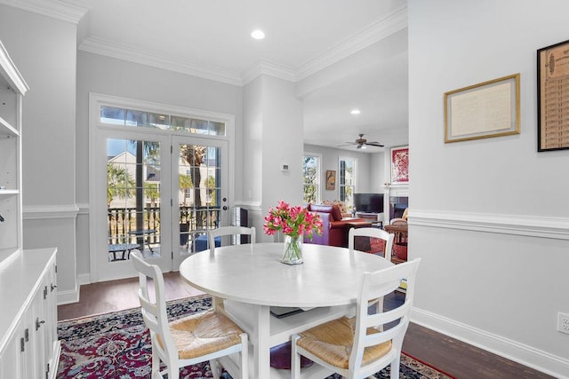 dining space with dark hardwood / wood-style floors, ceiling fan, and ornamental molding