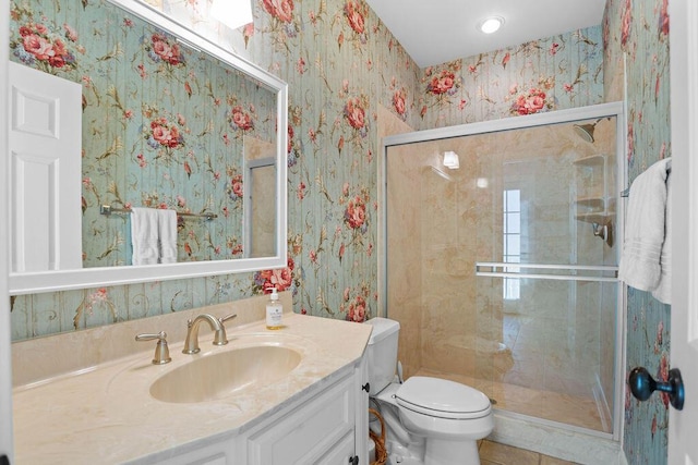 bathroom featuring tile patterned floors, a shower with door, vanity, and toilet