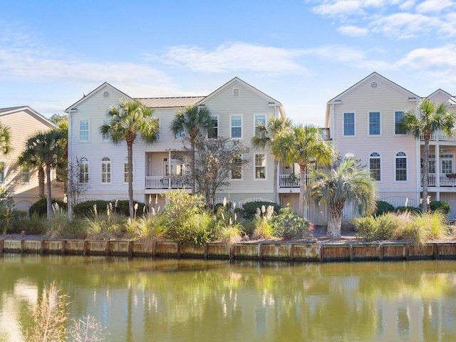 back of property featuring a water view