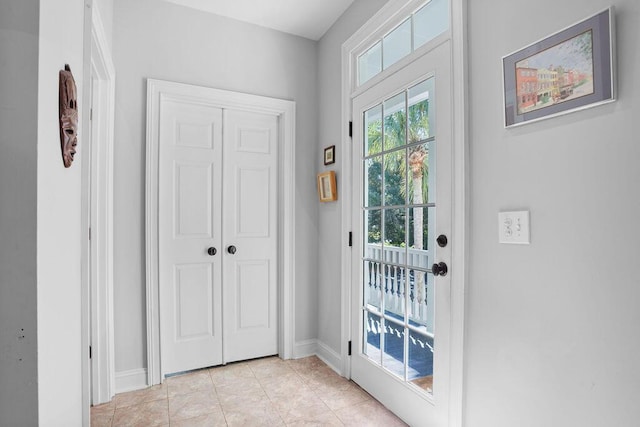 doorway to outside featuring light tile patterned flooring