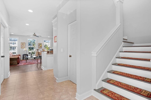 staircase with tile patterned flooring and ceiling fan