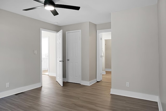 spare room with ceiling fan and dark hardwood / wood-style flooring