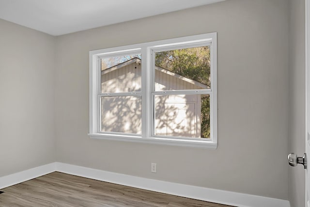 empty room with plenty of natural light and wood-type flooring