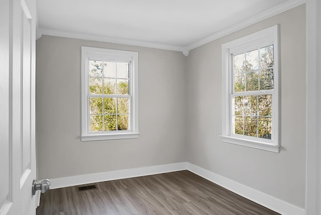 spare room featuring crown molding and hardwood / wood-style floors