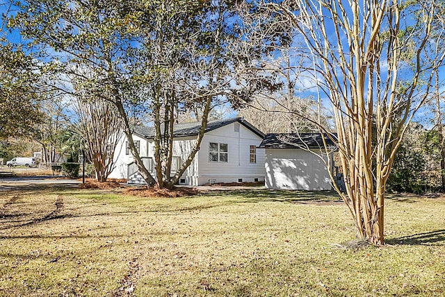 view of side of home featuring a lawn