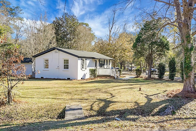 exterior space with a porch and a front yard